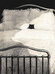 A monochrome artwork depicting a black cat peeking out from a bed with white bedding and dark metal bed rails, rendered in a sketch-like style against a dark background.