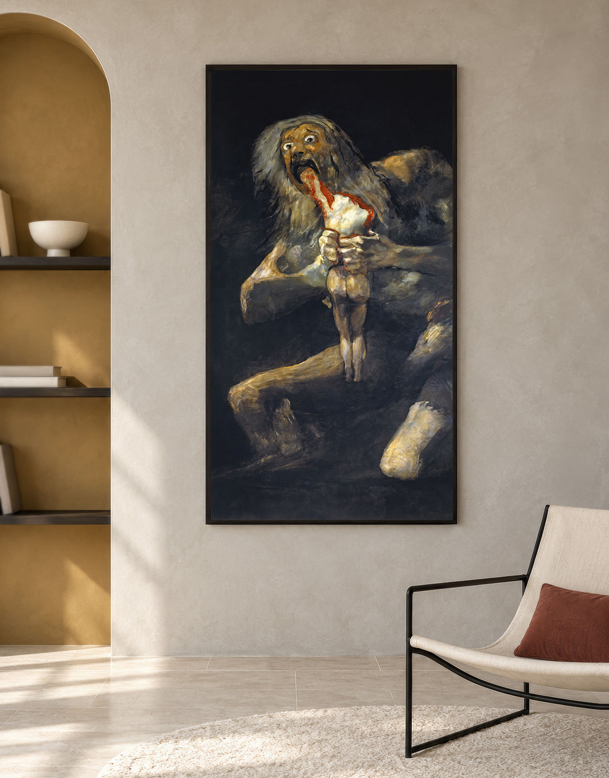 A vertical framed wall art print depicting a dark, dramatic fantasy creature holding a small white animal, displayed on a beige wall in a modern interior with a chair and shelving visible.