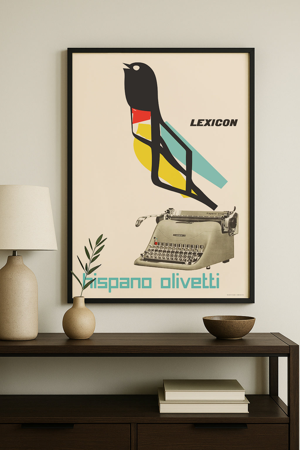 A framed vintage-style poster hangs on a light gray wall above a dark wood console table. The poster features a black bird silhouette with red, yellow, and teal geometric accents, a beige typewriter, the word 'LEXICON' at the top, and 'bisano olivetti' at the bottom.