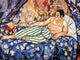 An expressive painting of a reclining woman on a bed, rendered in rich blues, creams, greens, and warm skin tones. The scene includes patterned bedding, draped fabric, and a red book on the bed.