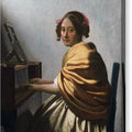 A Young Woman Seated at the Virginals - Canvas Print